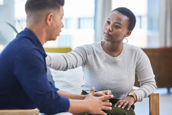 Black woman, office and console man in stress, panic or talking with mental health support in workplace. Professional, businesswoman and care for employee, coworker or management of work pressure.